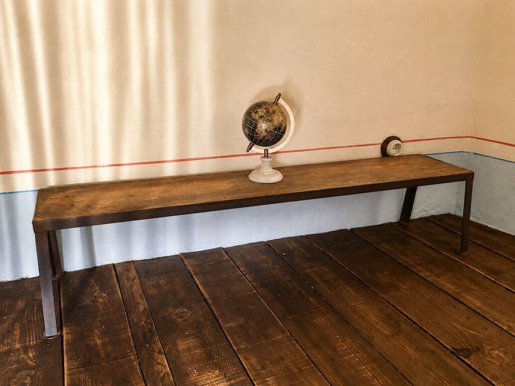 Console table with a globe in the Il belvedere apartment, Borgo Braila, Umbria