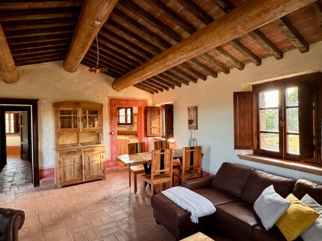 Living room with a handcrafted wooden dresser in the Il cavaliere apartment, Borgo Braila, Umbria
