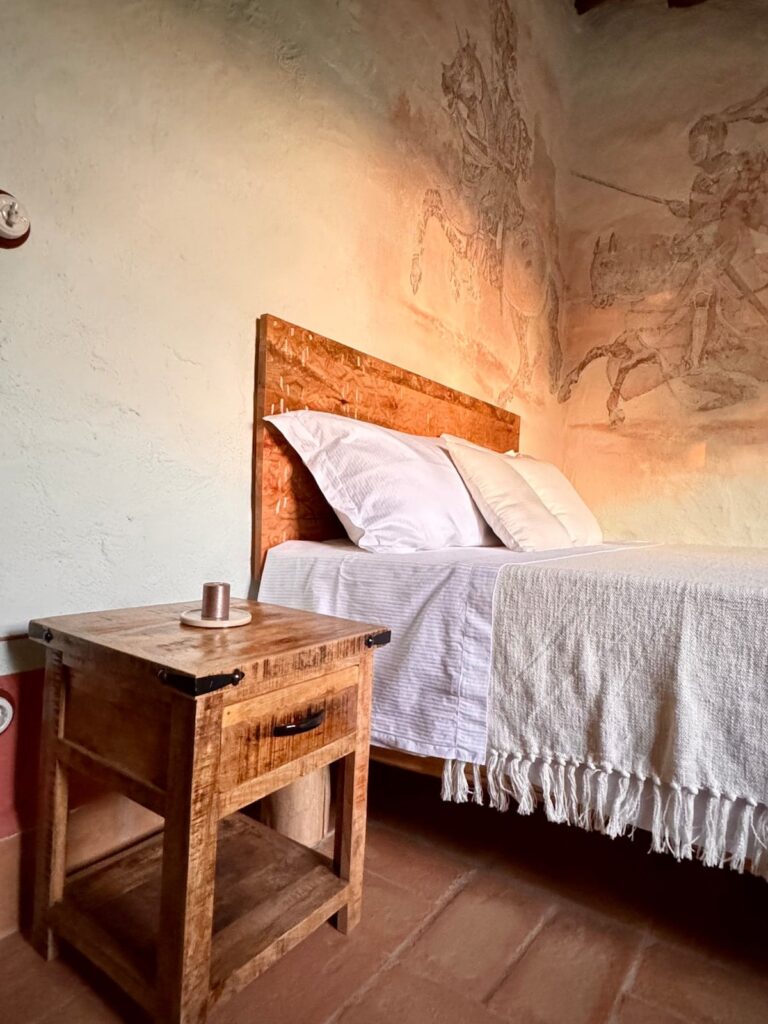 Double bedroom with softly painted walls in the Il cavaliere apartment, Borgo Braila, Umbria