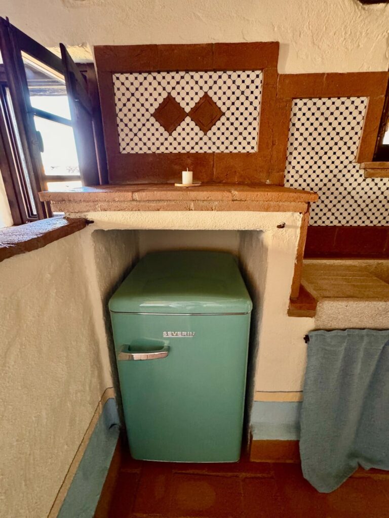 Kitchen with a retro refrigerator in the La carta apartment, Borgo Braila, Umbria
