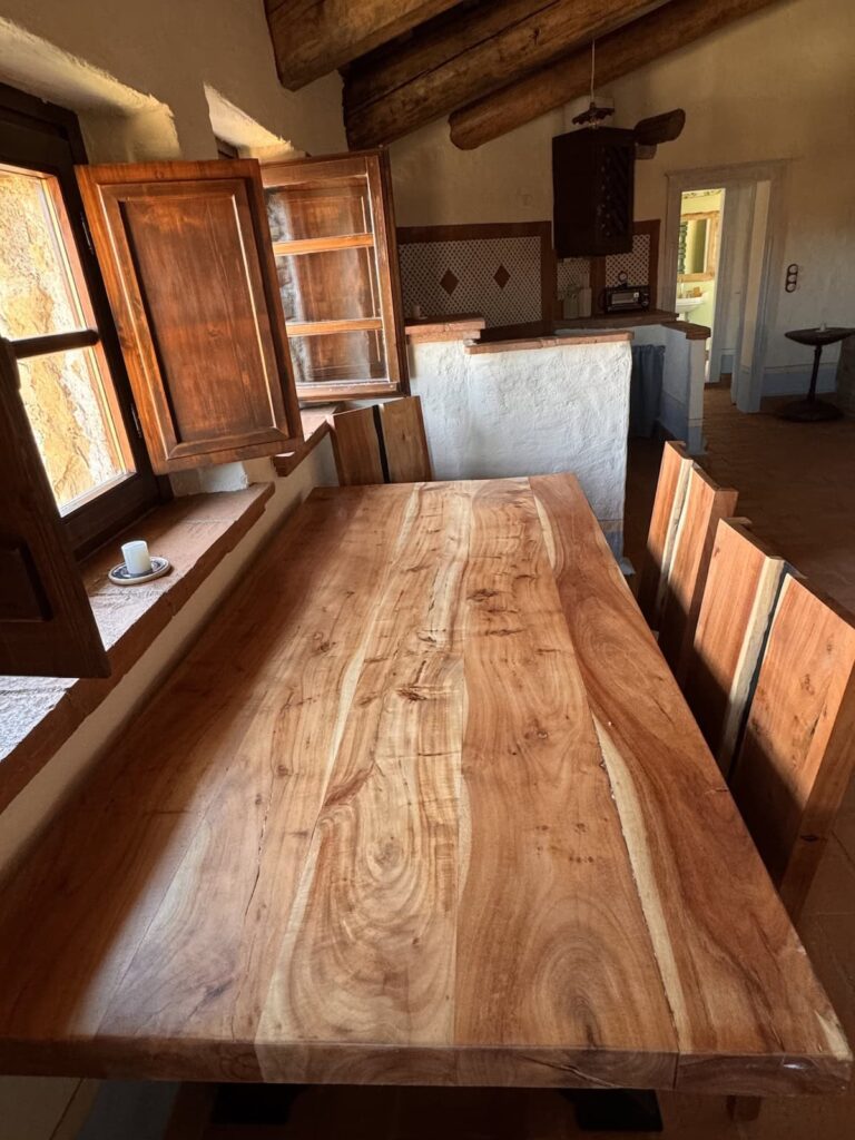 Rustic wooden dining table in the La carta apartment, Borgo Braila, Umbria