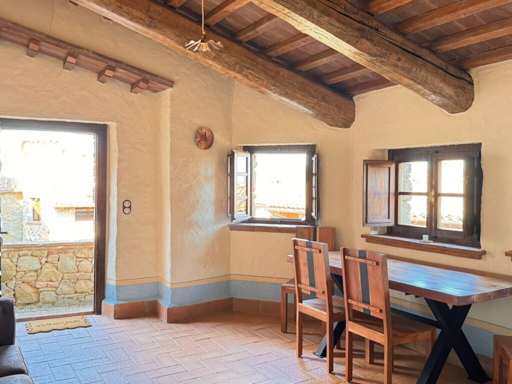 Dining table by the window in the La carta apartment, Borgo Braila, Umbria