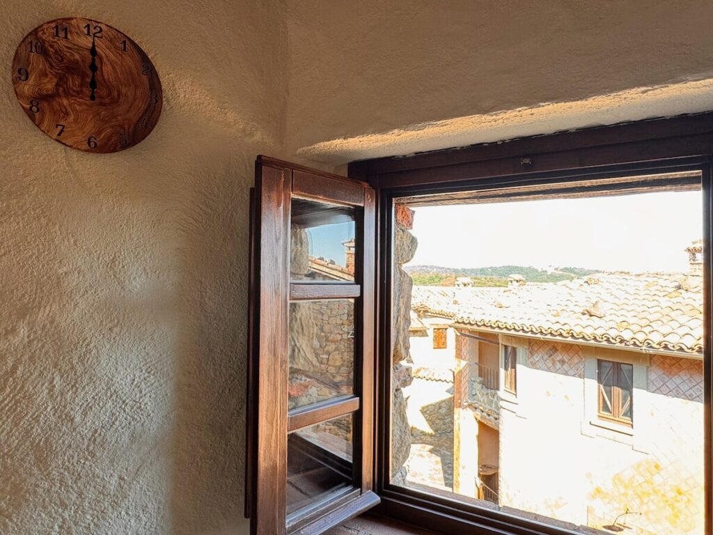 Open window with a village view in the La carta apartment, Borgo Braila, Umbria