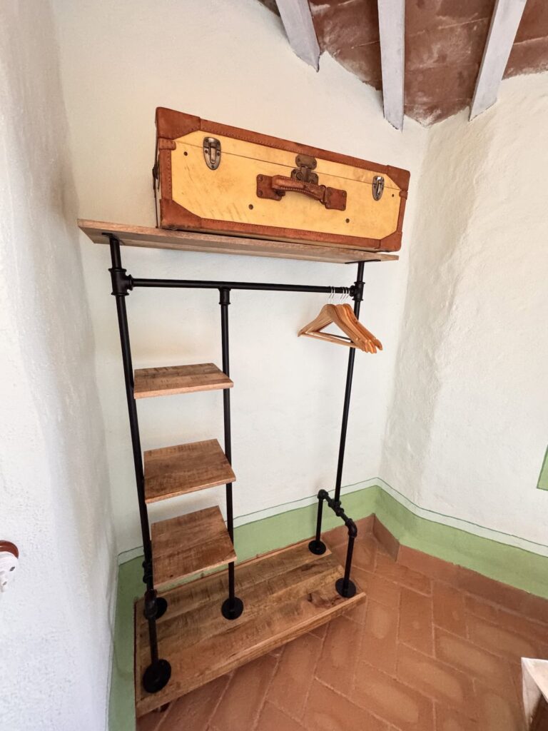 Wooden clothes valet detail in the La carta apartment, Borgo Braila, Umbria