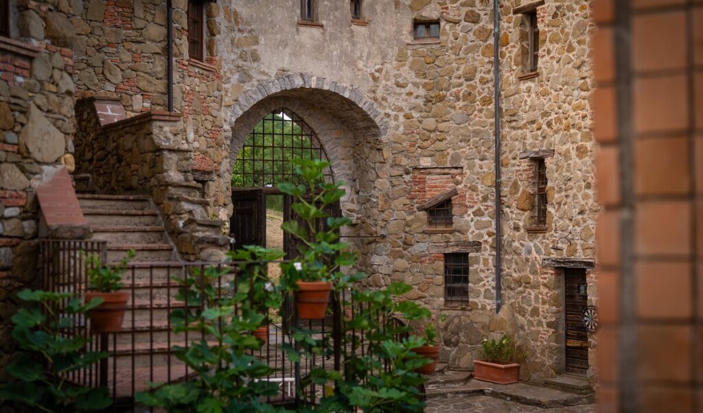 Stone archway of the village in the La carta apartment, Borgo Braila, Umbria