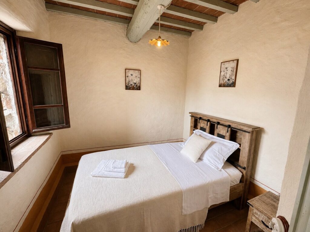 Bedroom with a double bed in the Il ponente apartment, Borgo Braila, Umbria