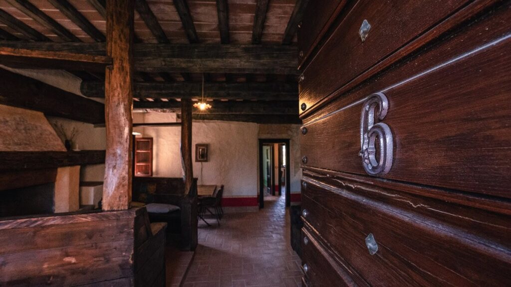 Living room with a dark wood dresser in the Il cardinale apartment, Borgo Braila, Umbria