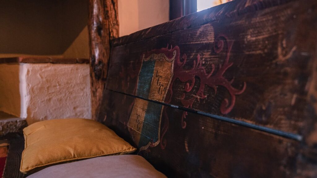 Detail of a hand-painted wooden beam in the Il cardinale apartment, Borgo Braila, Umbria