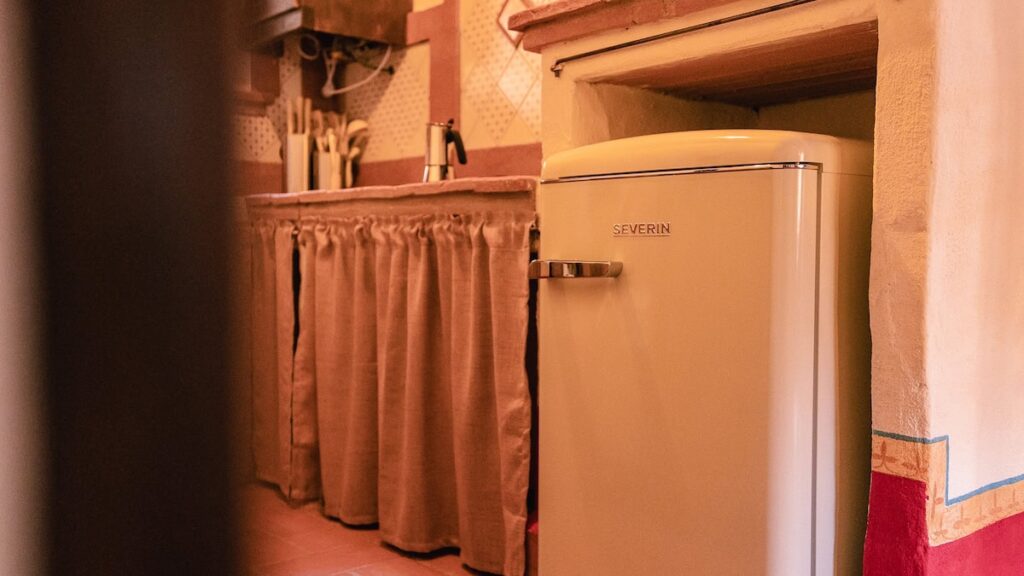 Kitchen with a retro refrigerator in the Il cardinale apartment, Borgo Braila, Umbria