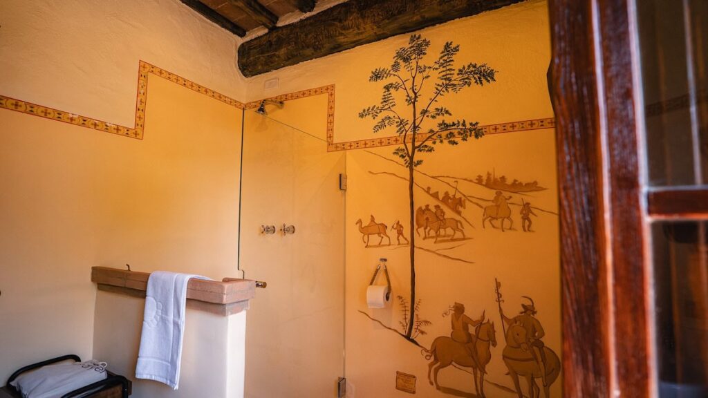 Bathroom with a painted botanical wall in the Il cardinale apartment, Borgo Braila, Umbria