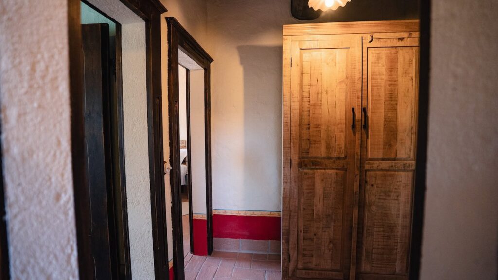 Hallway with wooden doors in the Il cardinale apartment, Borgo Braila, Umbria