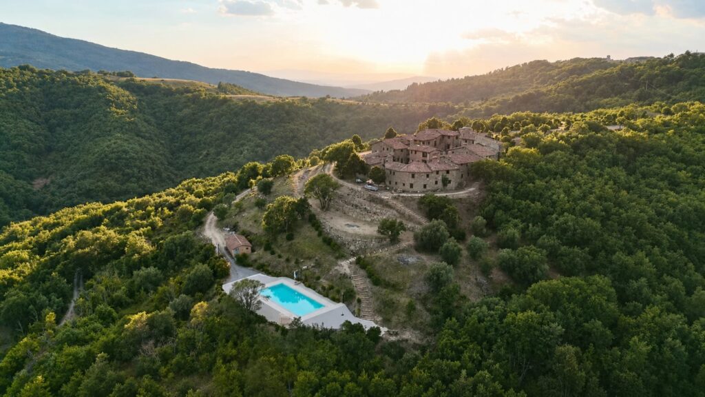 Aerial view of restored Borgo Braila among the Umbrian hills