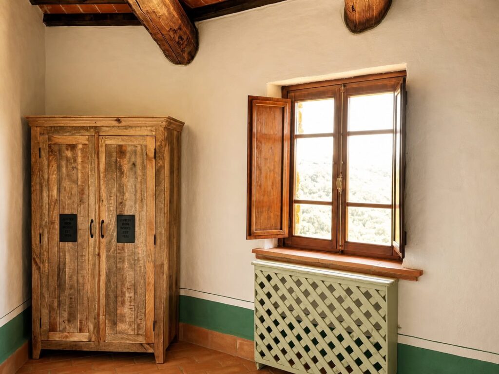 Bedroom with exposed beams and natural materials in a Borgo Braila apartment, Borgo Braila
