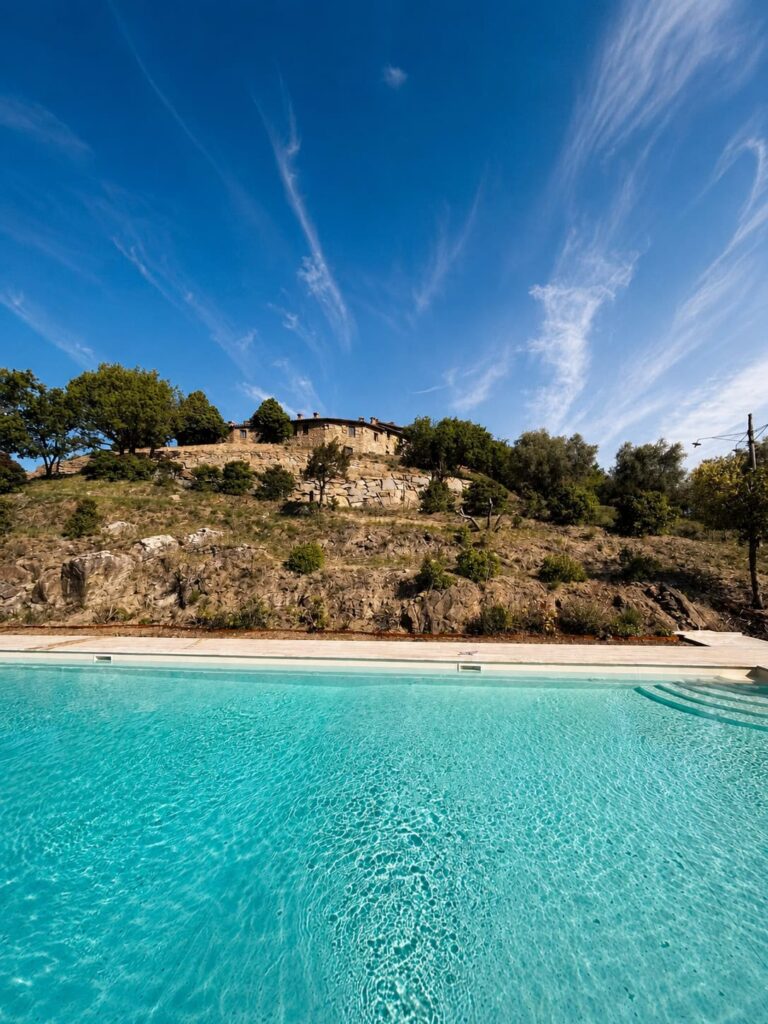 Panoramic travertine pool overlooking the Umbrian hills at Borgo Braila