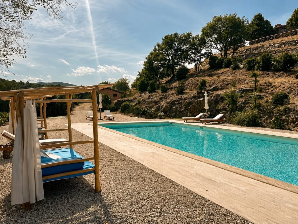 Panoramic travertine pool overlooking the Umbrian hills at Borgo Braila