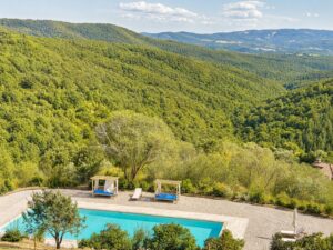 Travertine pool with panoramic views of the Umbrian valley at Borgo Braila