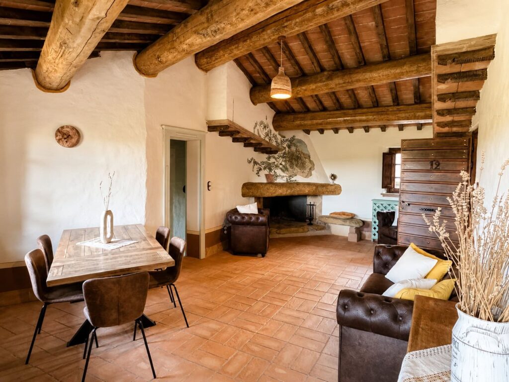Living room with fireplace in the Il belvedere apartment at Borgo Braila, Umbria
