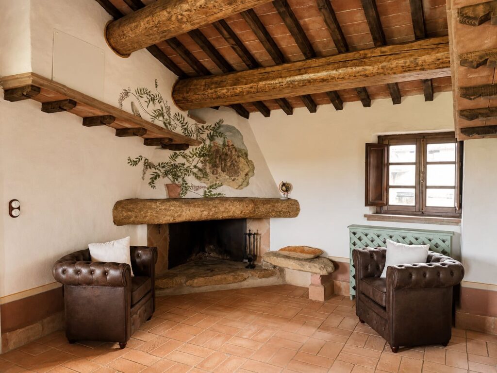 Living room with fireplace in the Il belvedere apartment at Borgo Braila, Umbria