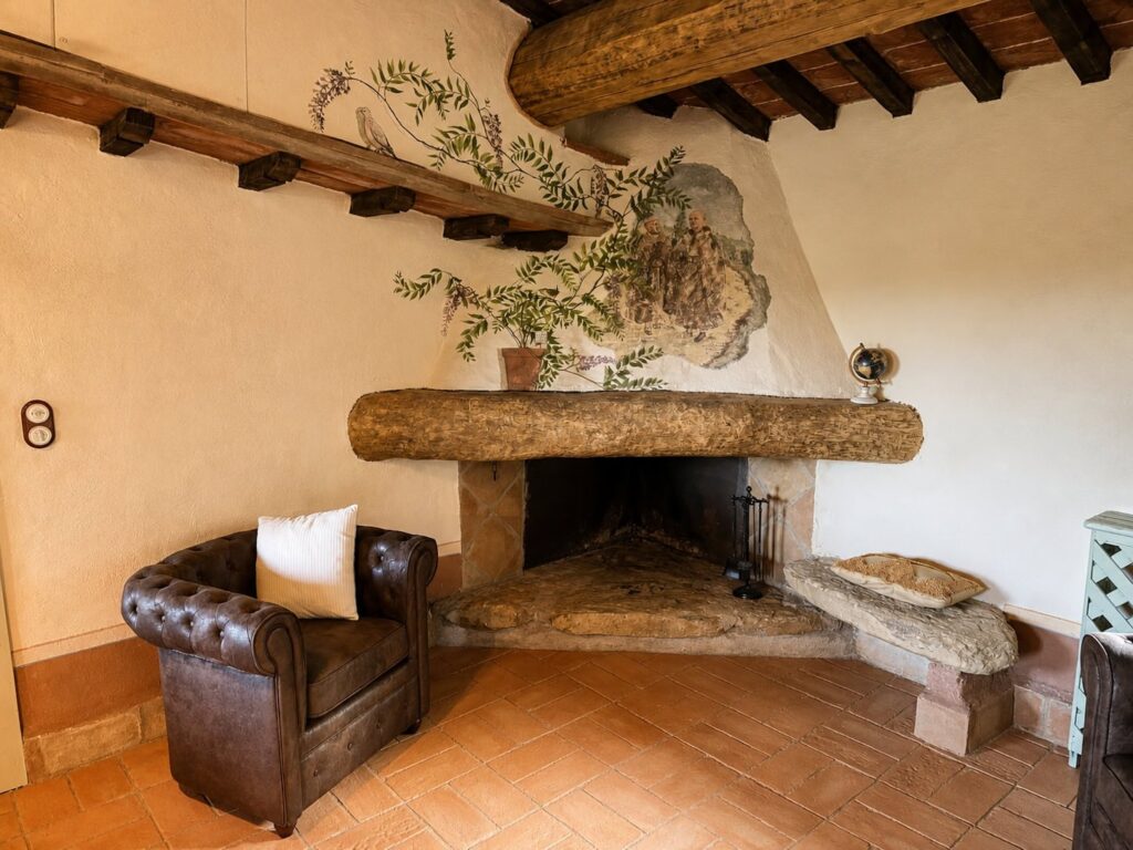 Living room with fireplace in the Il belvedere apartment at Borgo Braila, Umbria